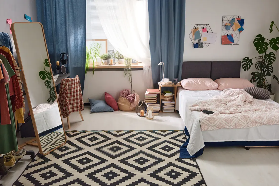 A double bedroom with the curtains open on a bright day